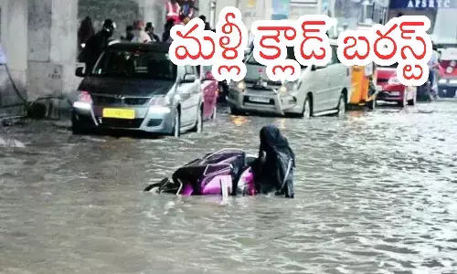 Flooded roads and stranded vehicles in Hyderabad during heavy rain and orange alert.