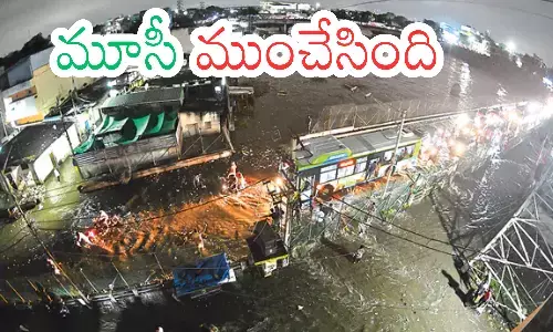 floodwaters submerge Hyderabad streets and MG bus station during heavy rains.