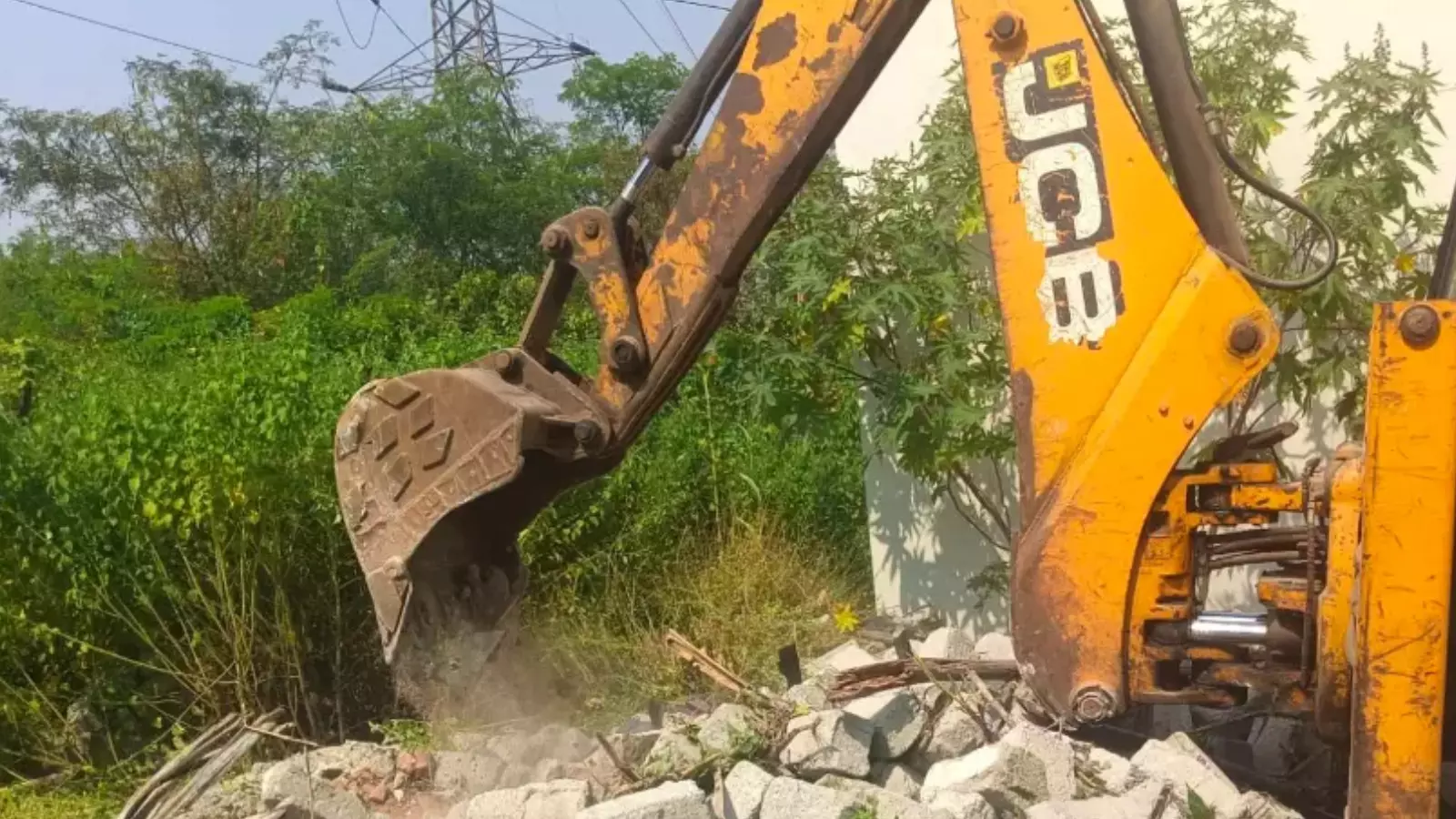 HYDRAA officials demolishing illegal construction on park land in Karmanghat HYDRAA officials demolishing illegal construction on park land in Karmanghat