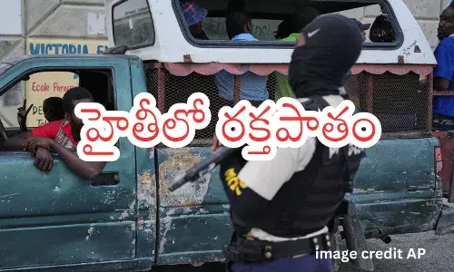 A police officer stands guard in Port-au-Prince, Haiti, A police officer stands guard in Port-au-Prince, Haiti,